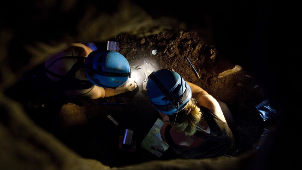 archaeologists digging in a cave