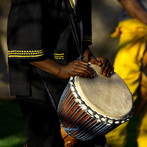 man playing African drum