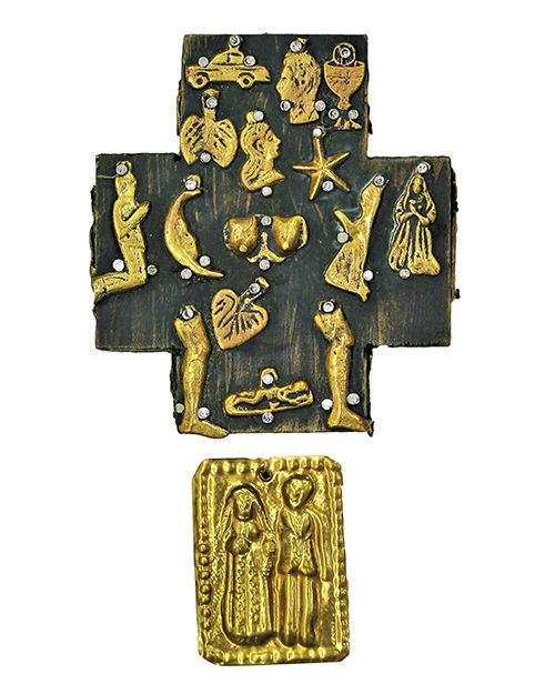 Small brass charms pinned to a cross