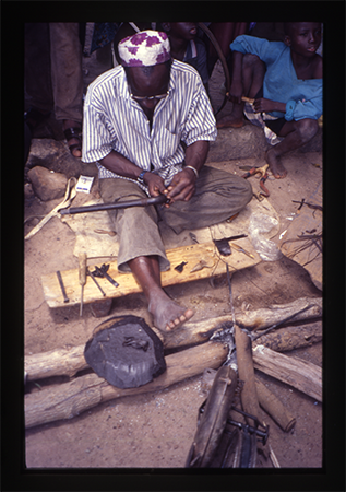 a metalworker making an axe