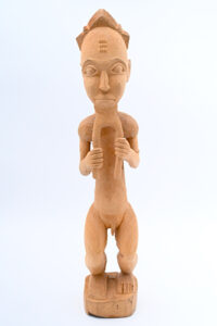 unpainted wood sculpture of a man