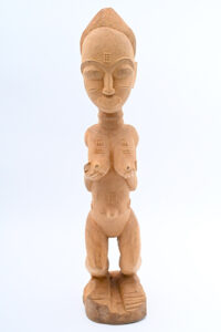 unpainted wood sculpture of a woman