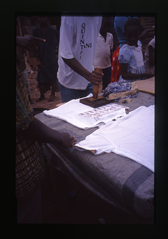 A man stamping a t-shirt