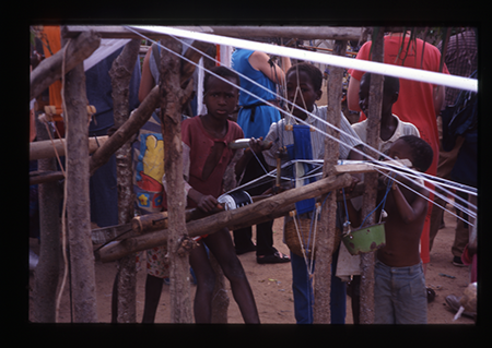 A child weaves on a loom