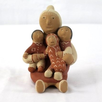 Ceramic figure of grandmother holding children