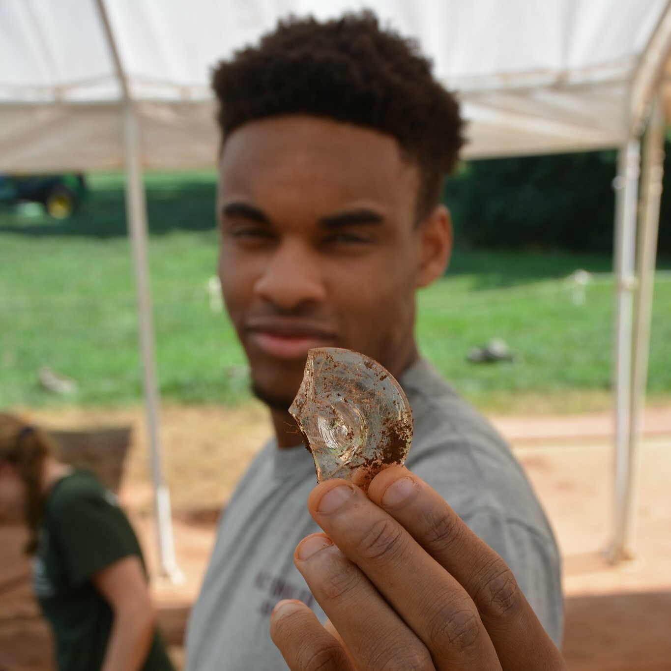 student holding an artifact