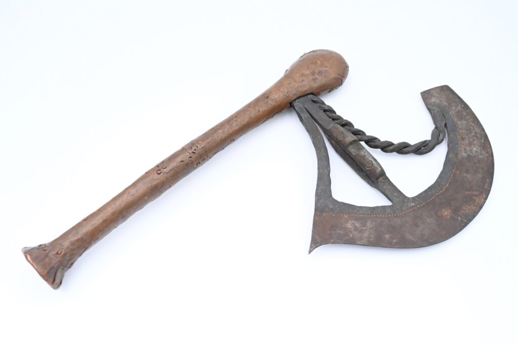 Axe with metal handle and decorated blade