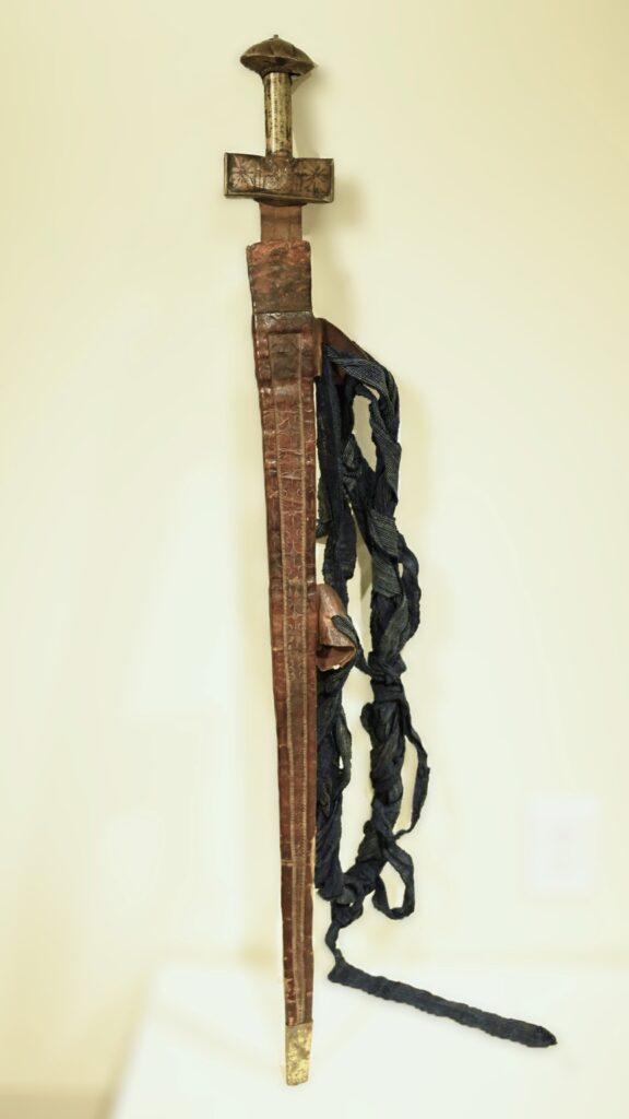 Sword in leather sheath with indigo cloth strap