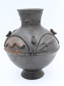 dark brown ceramic vessel with applied animals and designs