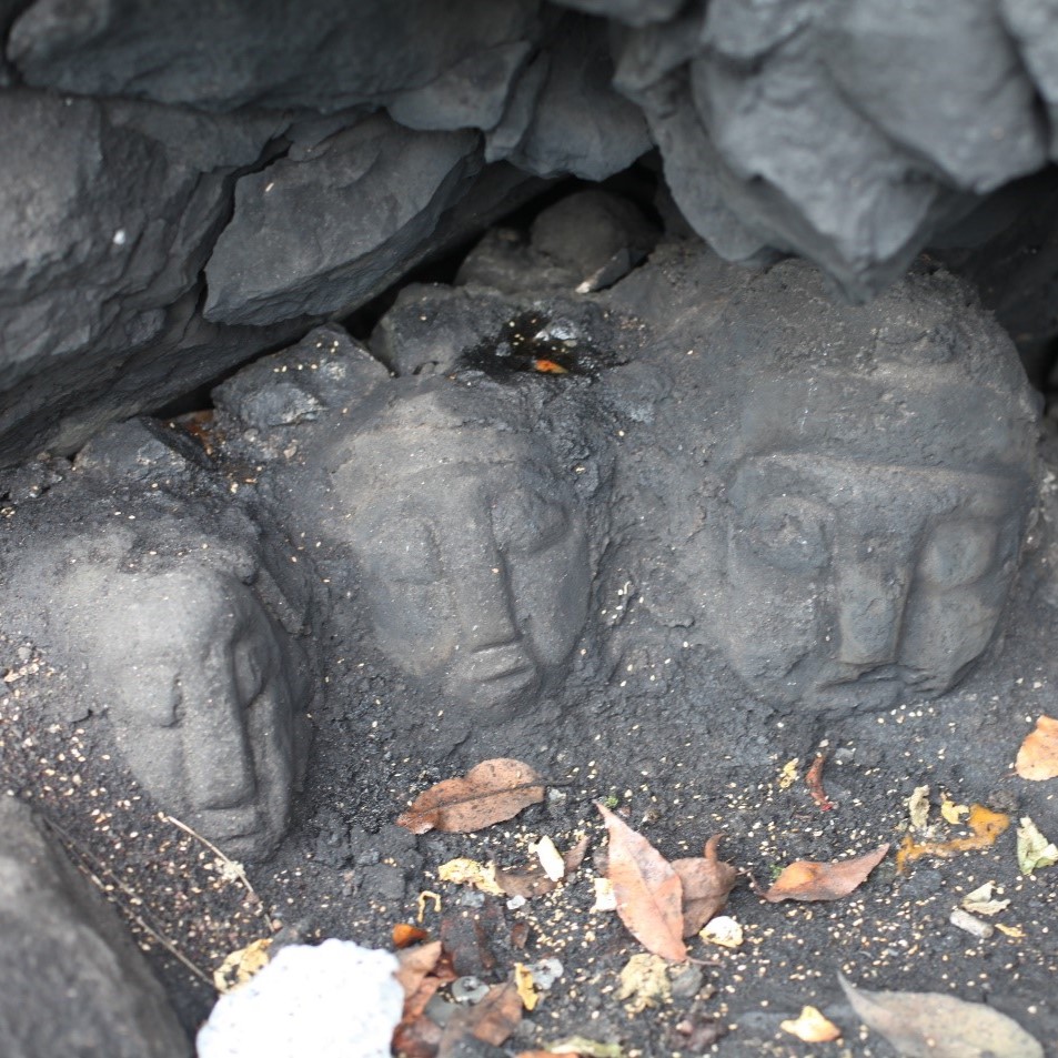 carved stone heads in a cave