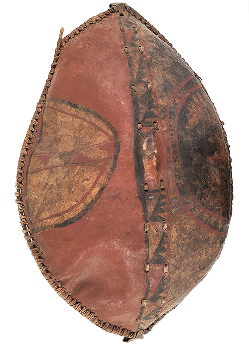 oval shaped shield with black and red designs