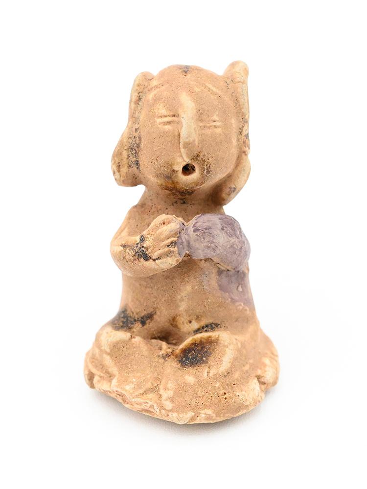 Miniature ceramic figure of a person with side buns