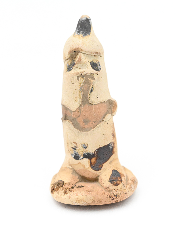Miniature ceramic figure of a person wearing a pointy hat