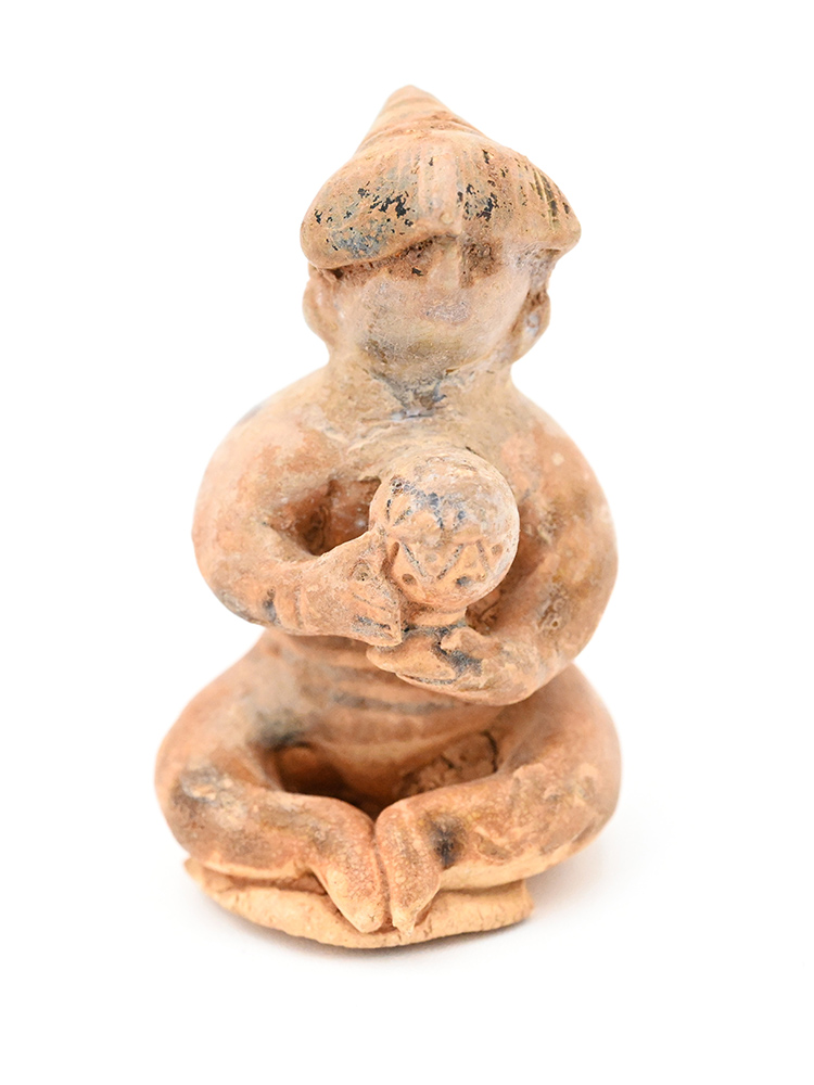 Miniature ceramic figure of a person wearing a pointy hat