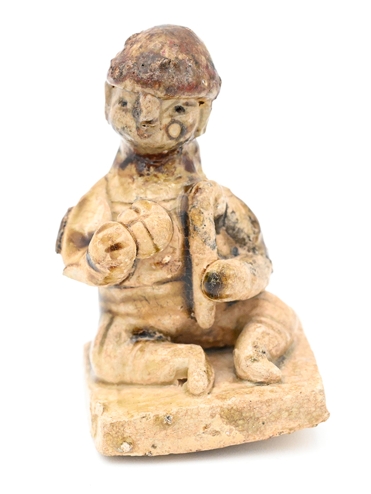 Miniature Ceramic figure of a person in a round hat 