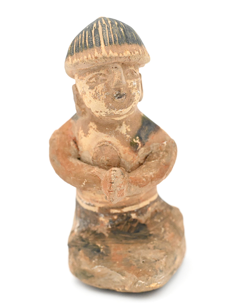 Miniature figure of a person wearing a hat