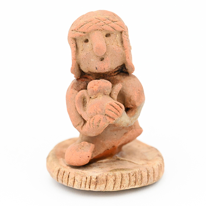 Ceramic figure of a person in a round hat with flaps