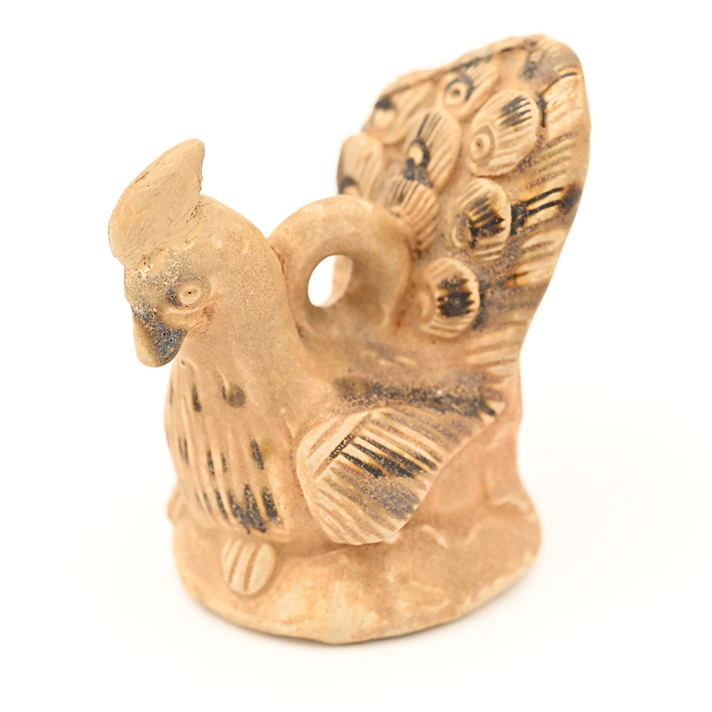 miniature ceramic figure of a peacock