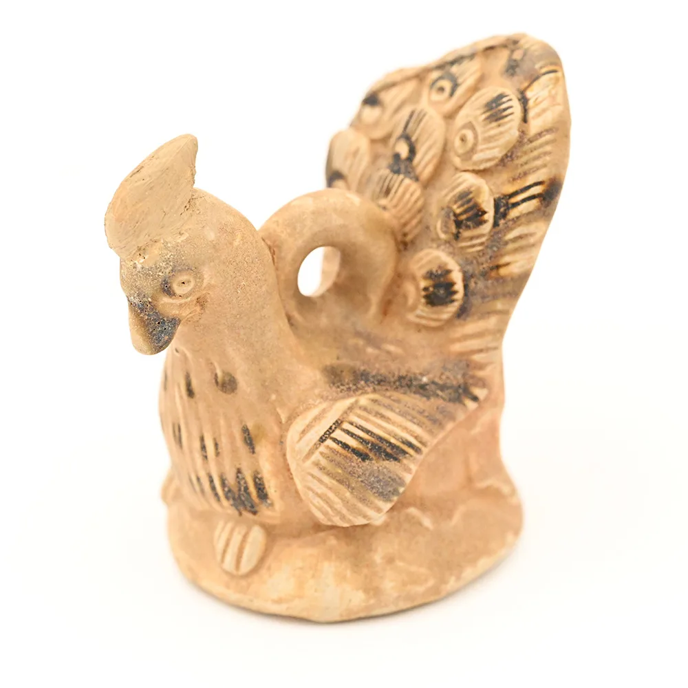 miniature ceramic figure of a peacock
