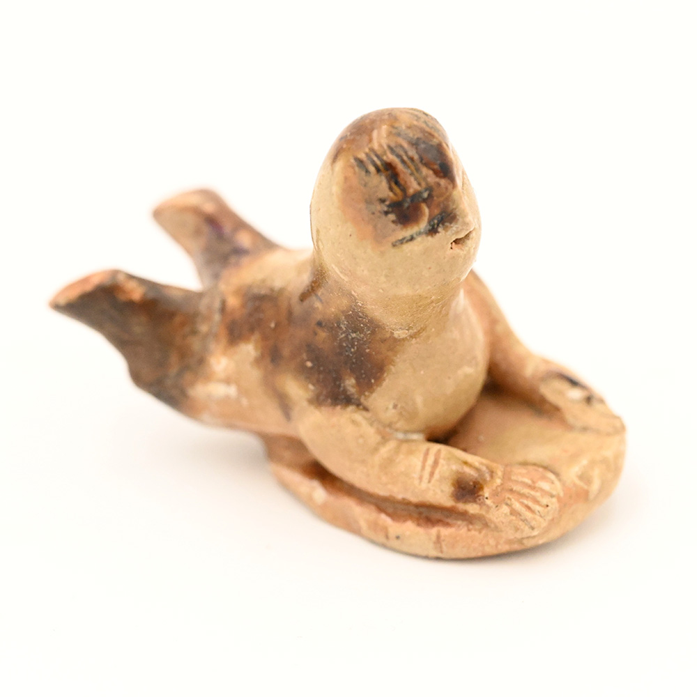 miniature ceramic figure of a person sledding