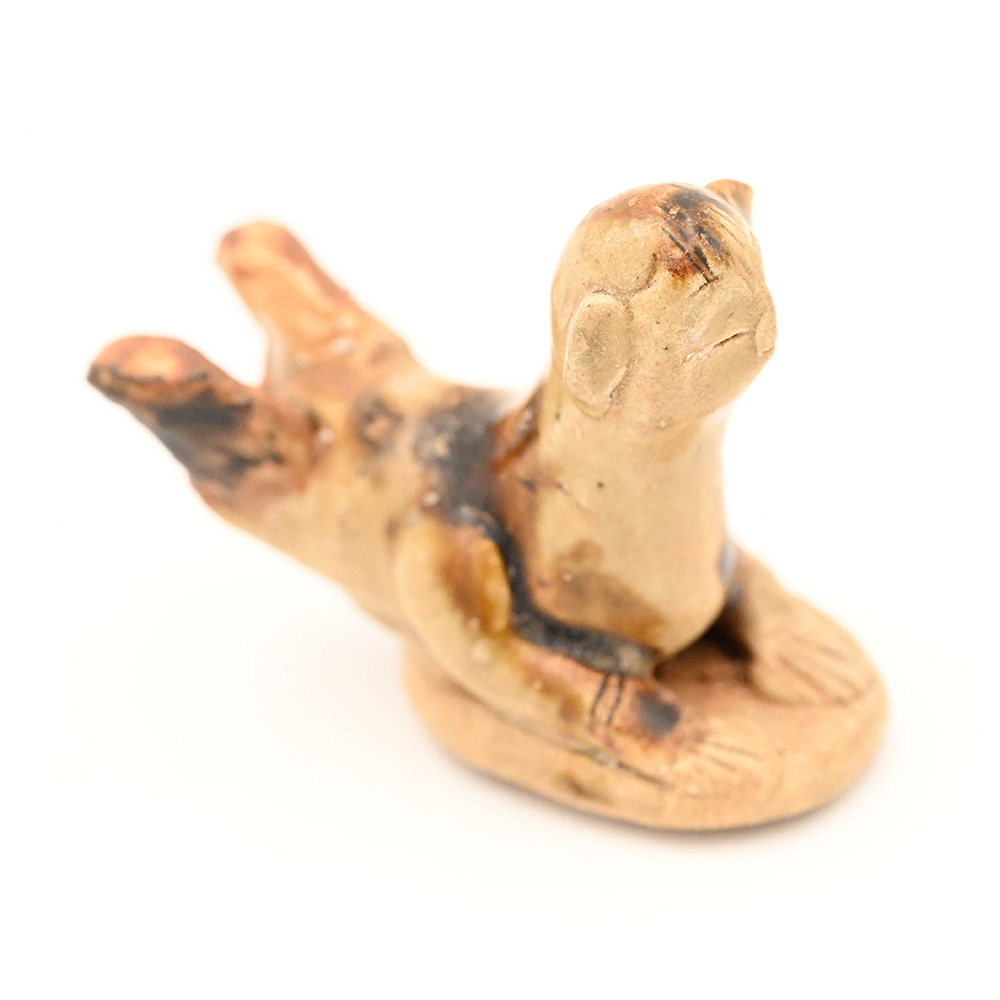 miniature ceramic figure of a person sledding