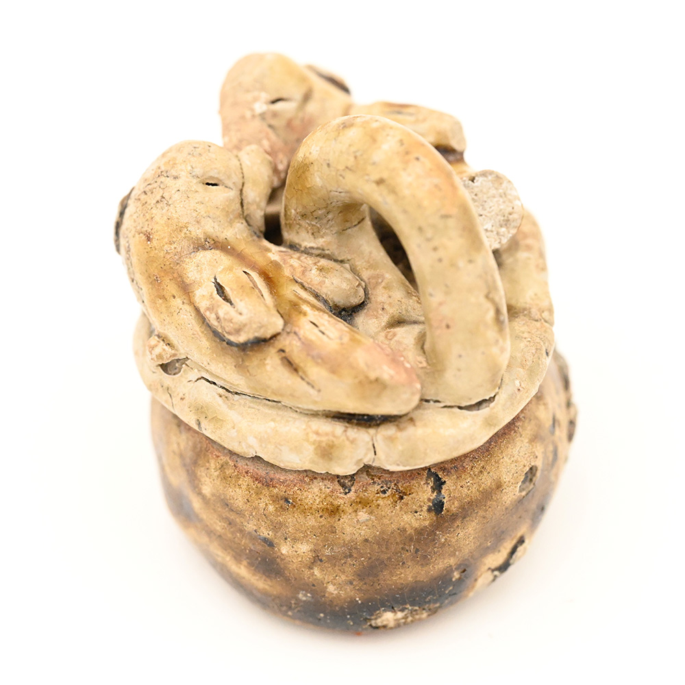 miniature ceramic figure in the shape of a basket with fish