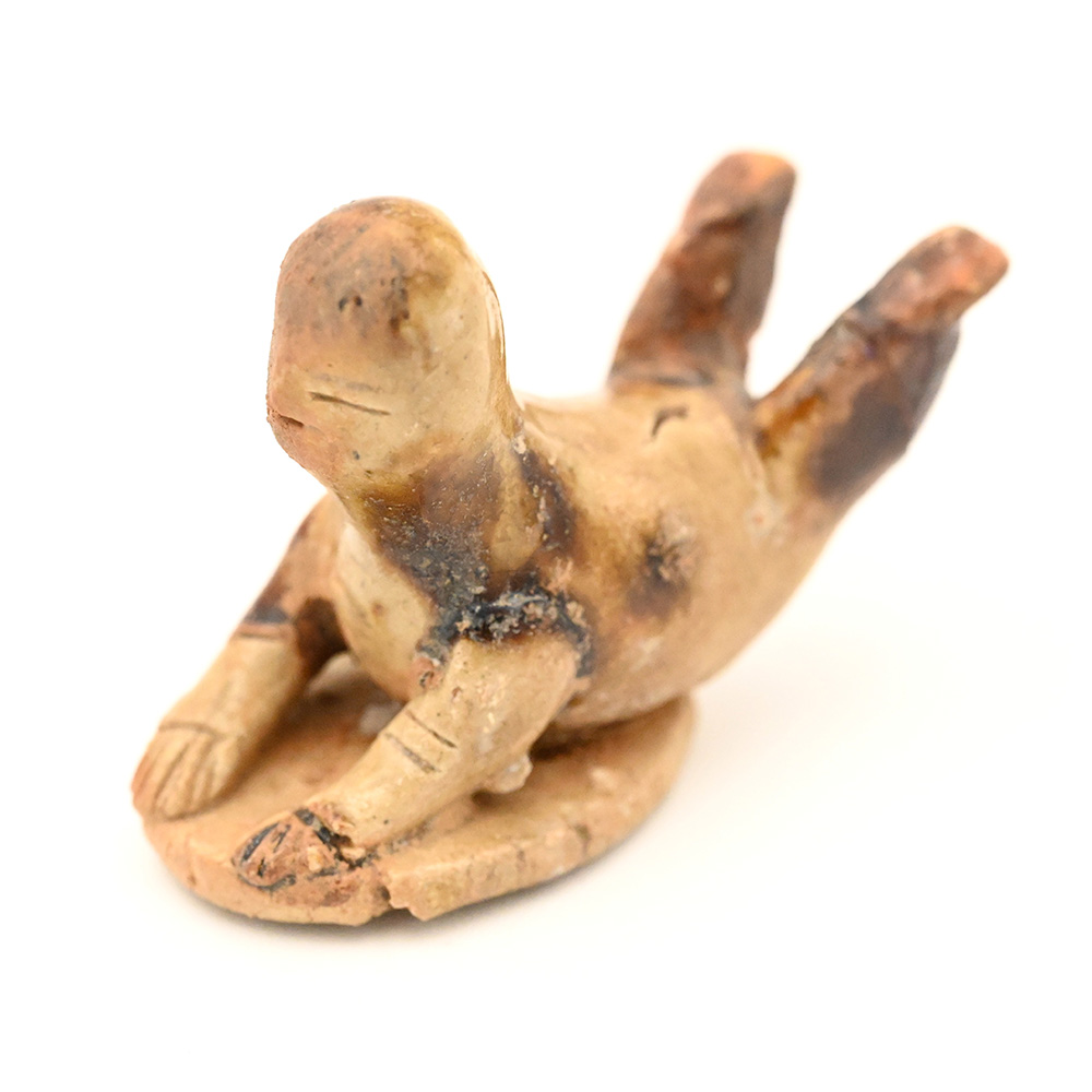 miniature figure of a person sledding