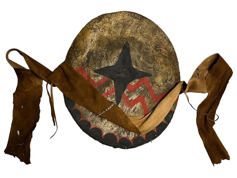 Leather shield with black star design and red lines