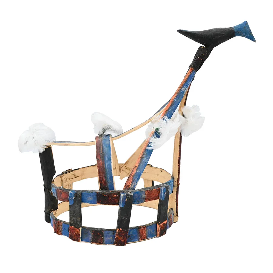 Crown made of blue wood strips with attached white feathers and a wooden bird