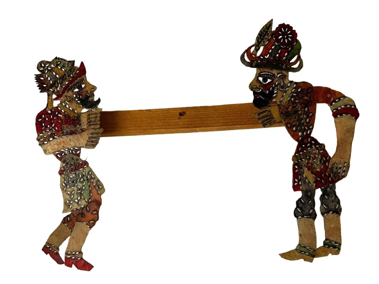 shadow puppet with wood bar connecting two flat human figures