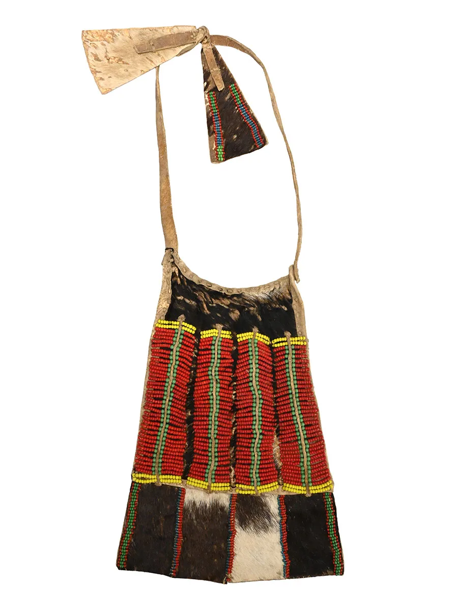 beaded animal hide skirt consisting of a flap in the front and strips to tie around the waist