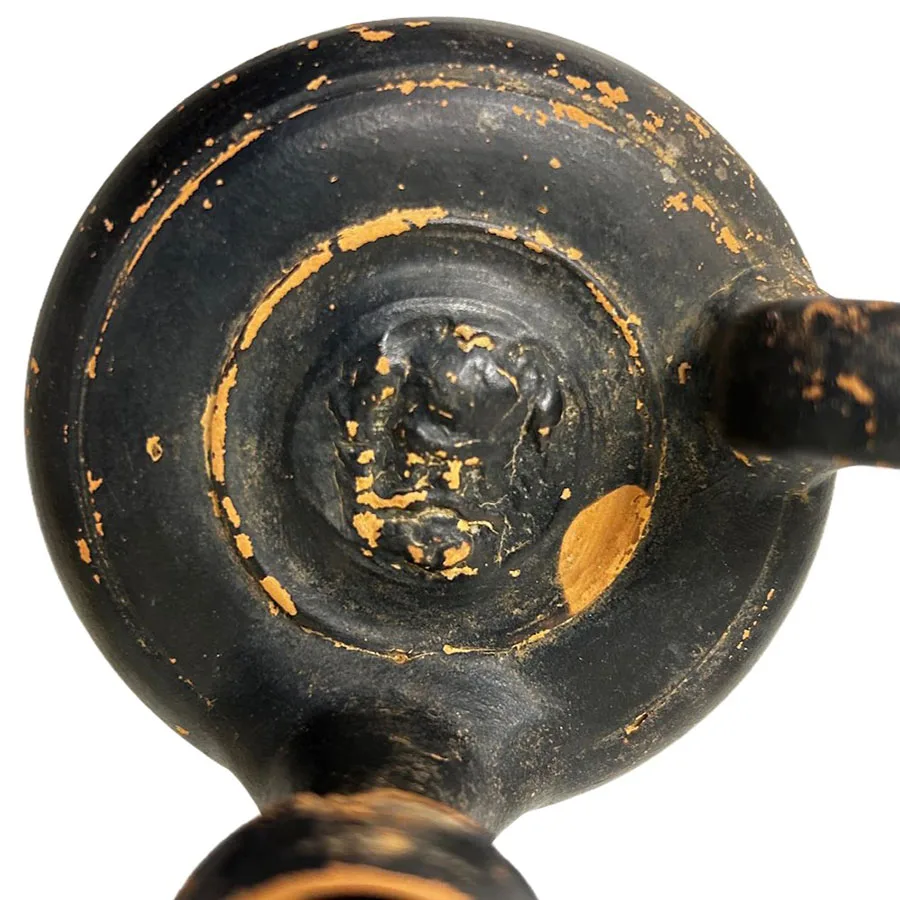 close up of satyr design in center of vessel