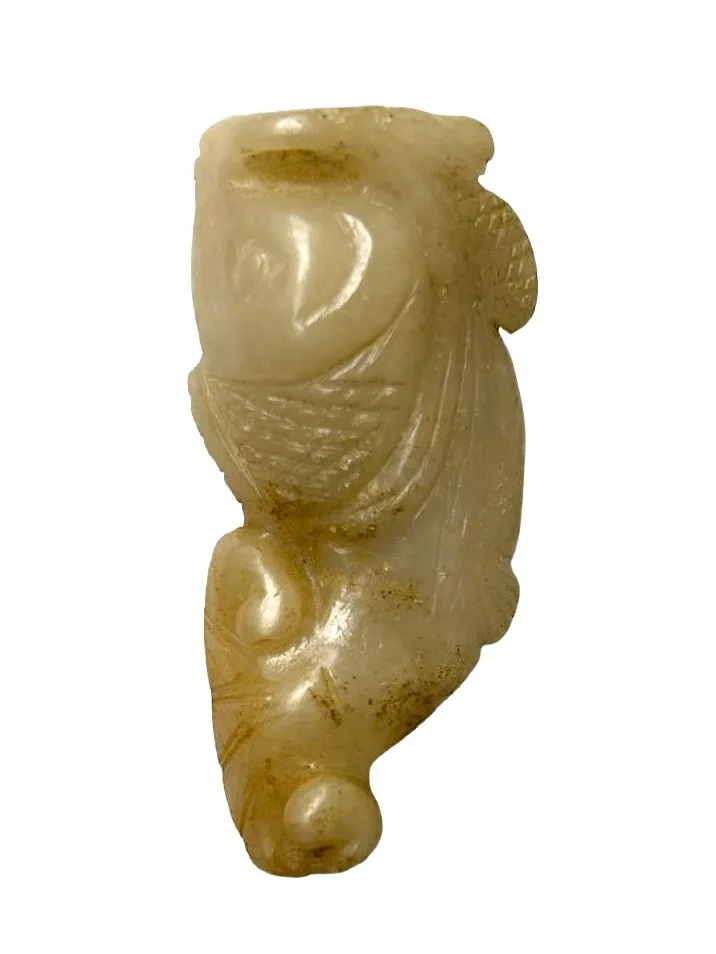 Small jade carving of a fish with a loop at the fish's mouth.