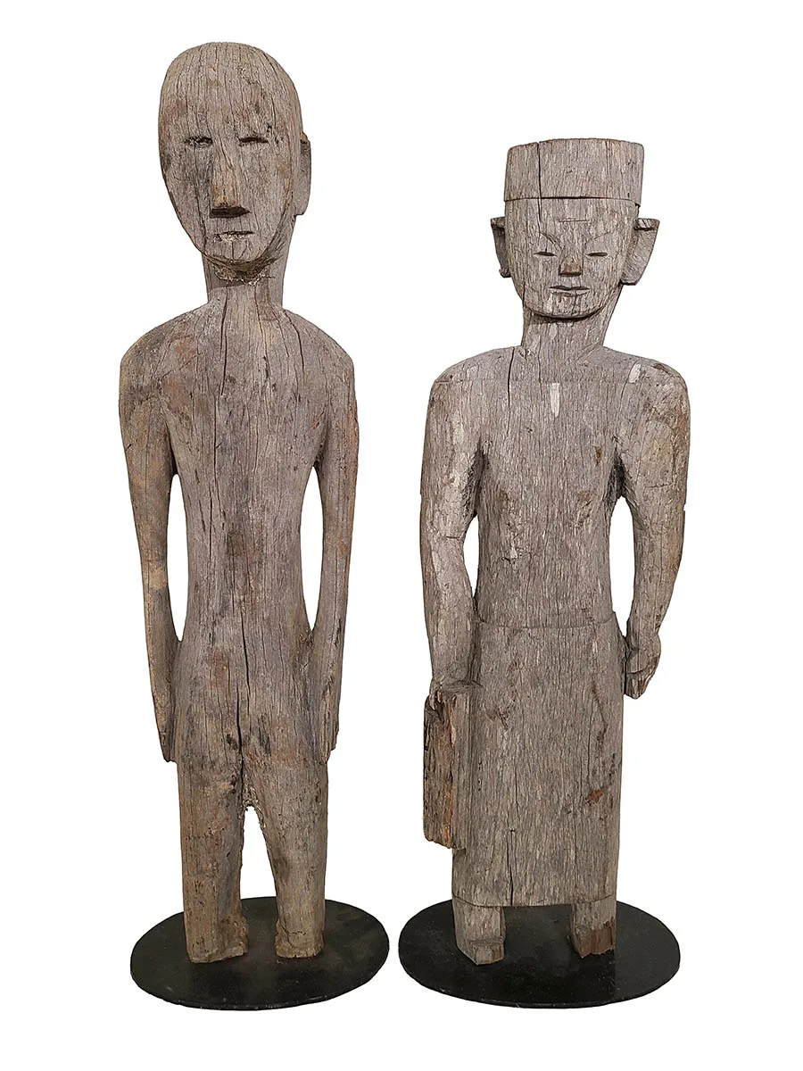 pair of wooden statues representing a man and woman