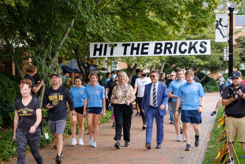 Members of the Wake Forest community participate in the annual Hit the Bricks for Brian cancer research fundraiser on Hearn Plaza on Thursday, September 30, 2021. More than 1700 people ran and walked around the quad to raise money. President Susan R. Wente walks laps for the event.