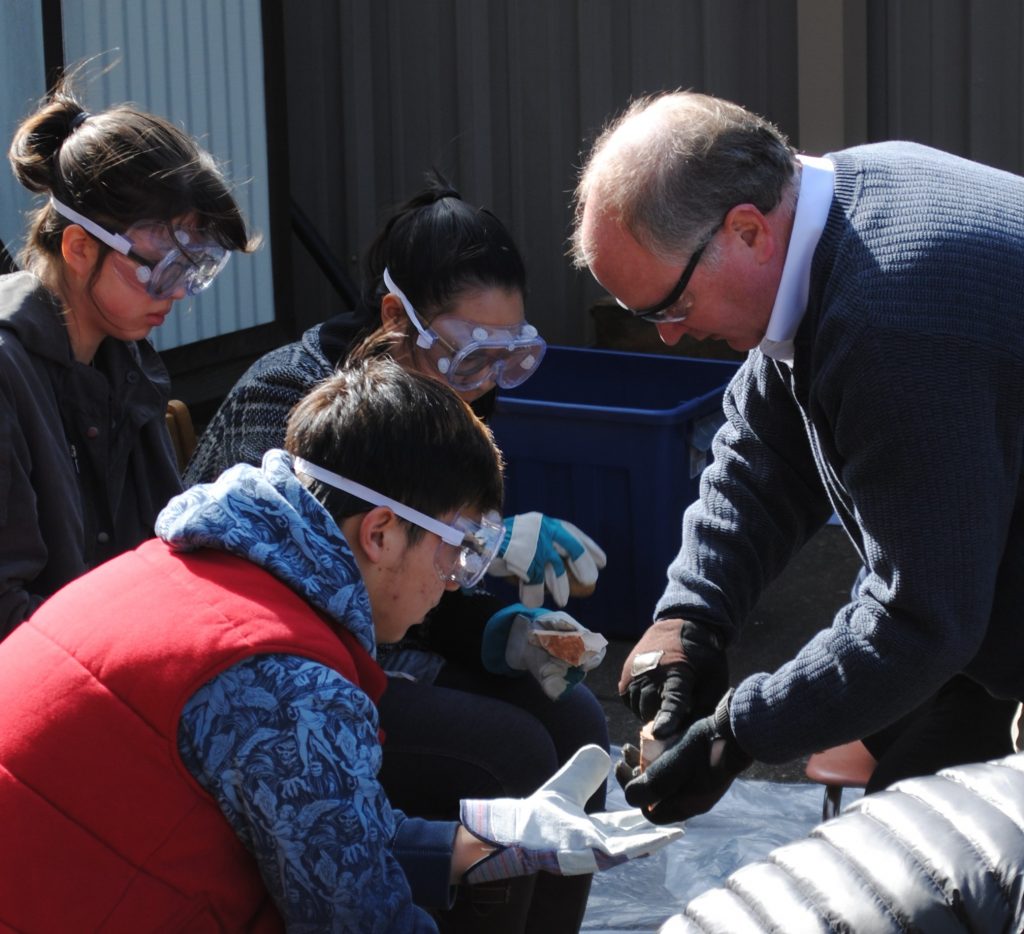 Dr. Thacker instructing students on knapping