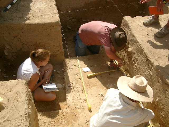 WFU students in Portugal measuring distance in excavated building