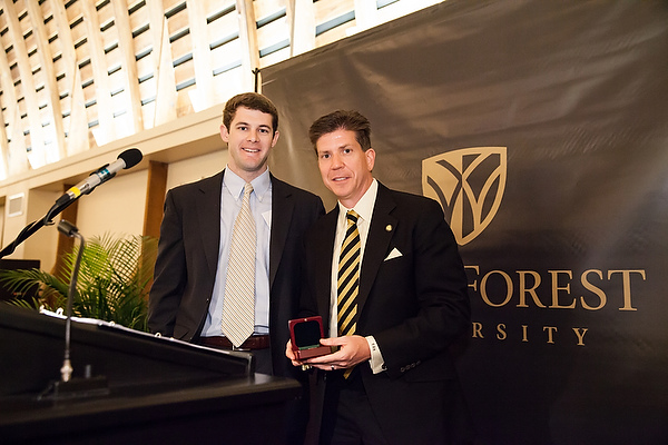 Wills Denton ('10) accepting the award on behalf of his late father, Graham W. Denton Jr.