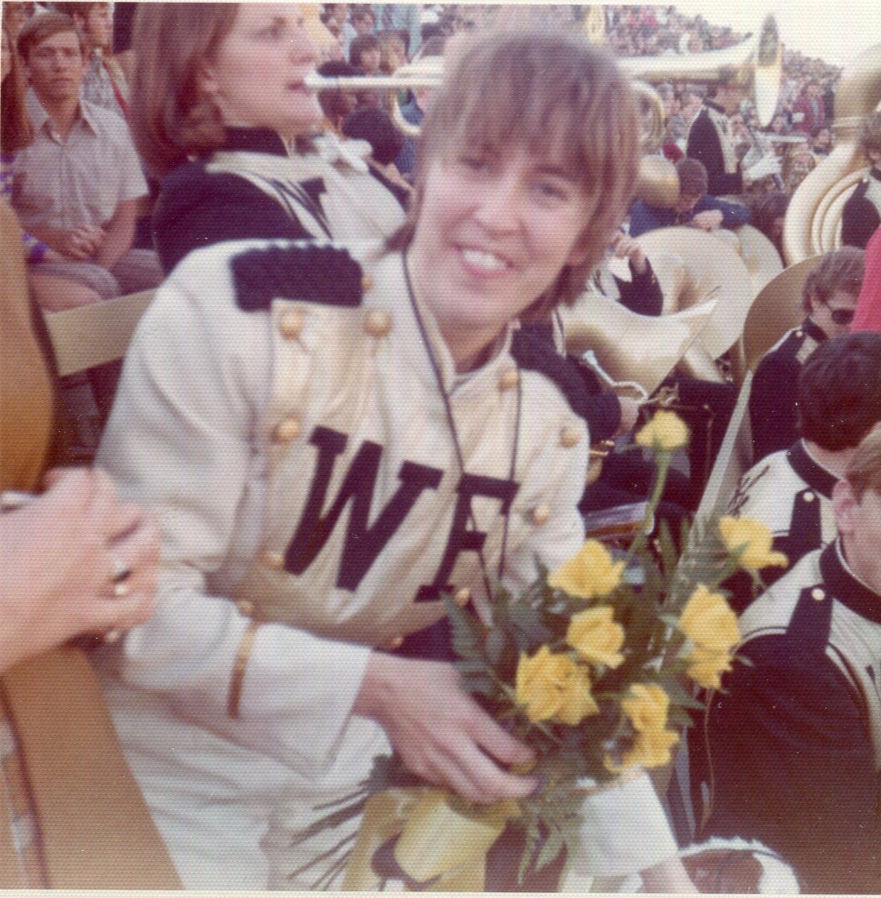 President Scales presented yellow roses to Pam Key at her last game as drum major.