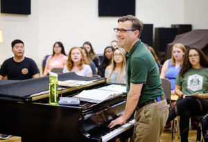 Standing at a piano in front of students, Wake Forest Associate Professor of Music Brian Gorelick (P '17) teaches the concert choir class in Scales Fine Arts Center, September 2019.