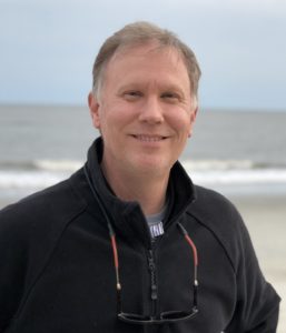 Chris Mowry stands on the beach