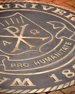 The seal of Wake Forest University is embedded in the brick walkway on Hearn Plaza.