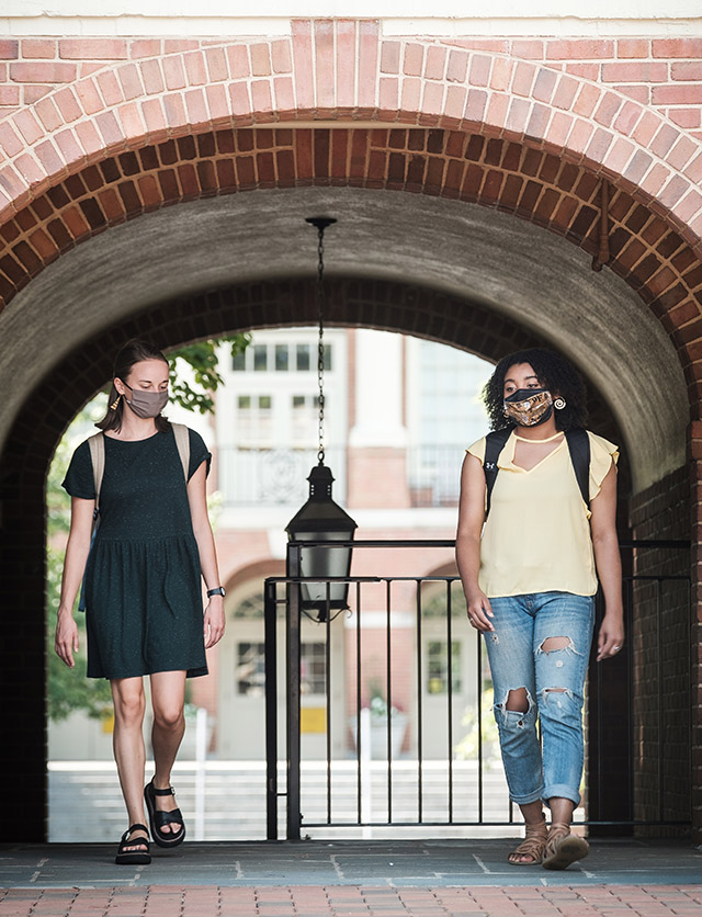 Wake Forest students and recent graduates demonstrate a socially distanced and properly masked campus, on the campus of Wake Forest University, Tuesday, July 28, 2020. Ellie Bruggen (’20) and Monet Beatty (’20) talk outside Davis Residence.
