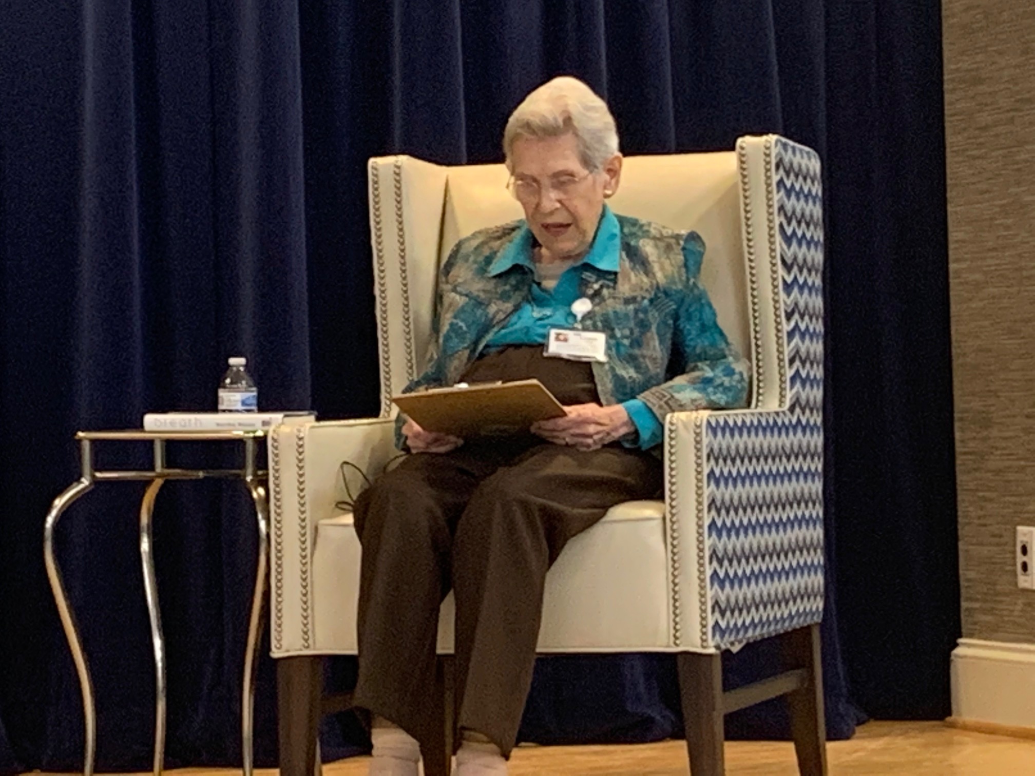 Lorna Lane introduces Mary Dalton on stage at River Landing retirement community in High Point, NC