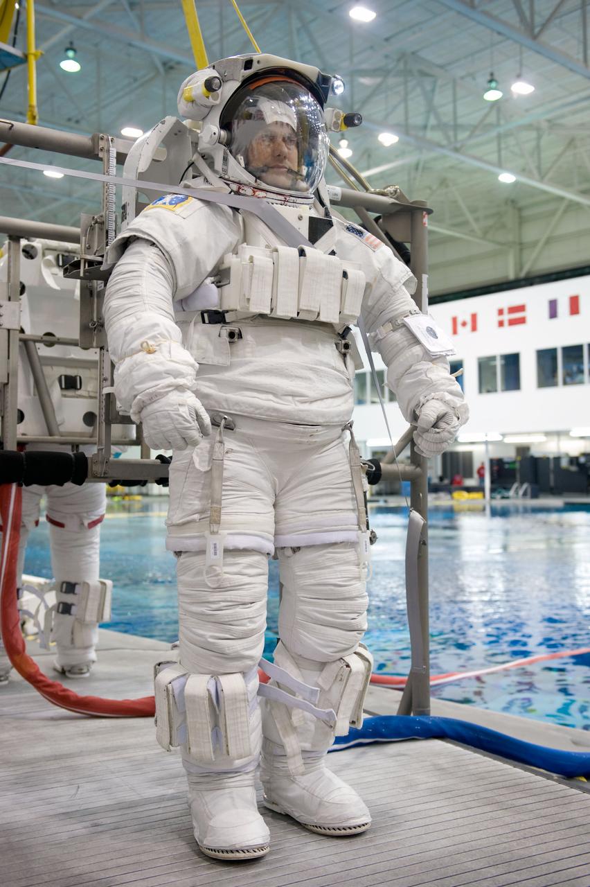 Astronaut Tom Marshburn, STS-127 mission specialist, attired in a training version of his Extravehicular Mobility Unit (EMU) spacesuit, awaits the start of a training session in the waters of the Neutral Buoyancy Laboratory (NBL) near NASA's Johnson Space Center.