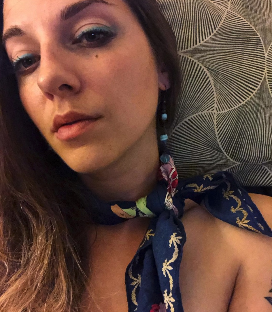 Closeup of Alex Koblan ('13) with a blue print scarf around her neck.
