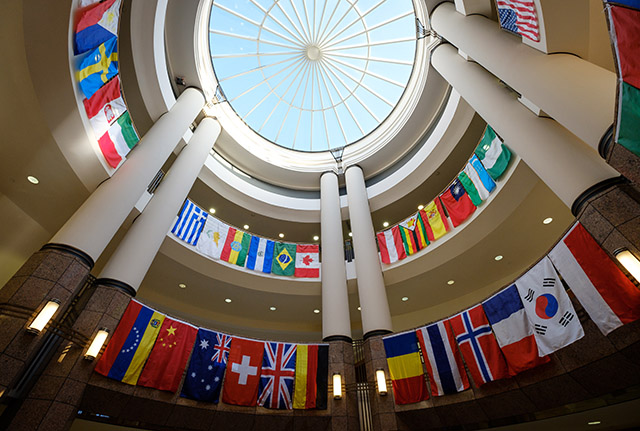 Flags from many nations hang in the atrium of the Benson Center.