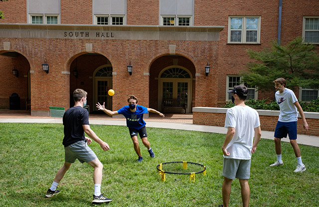 Students play spikeball outside South Residence Hall, part of "Freshmanland," a collection of seven dorms for first-year students on South Campus.