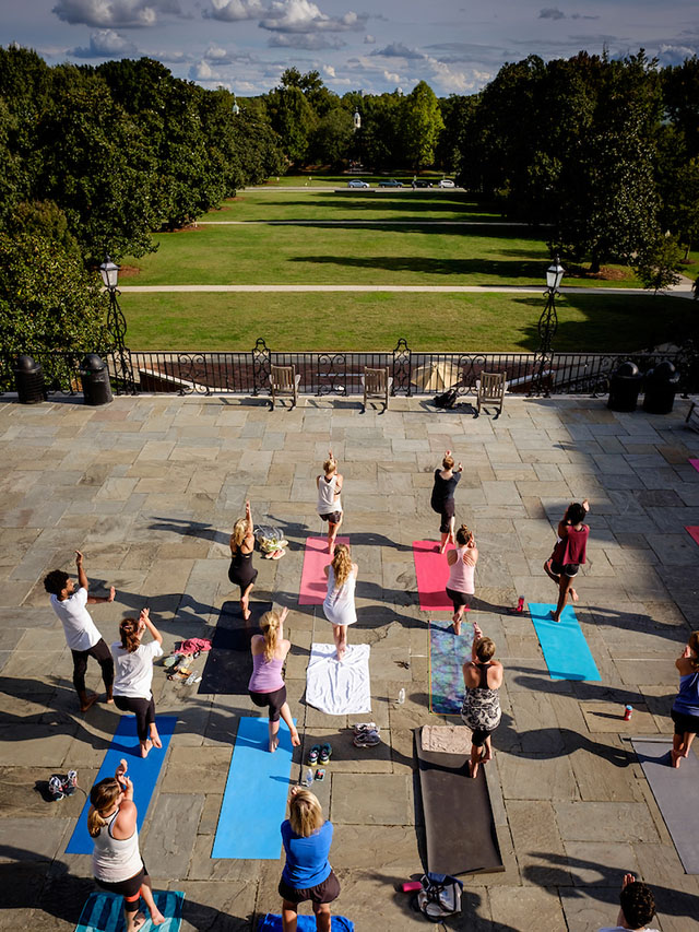 Wake Forest students and staff practice yoga on the Magnolia Patio under the direction of teacher Elliott Watlington on Wednesday, September 30, 2015.