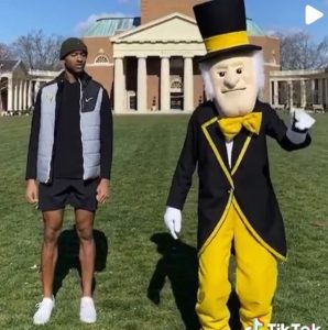 Matt James ('14) stands on the Quad with the Demon Deacon